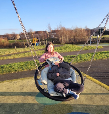 Ailbhe pushes Elliot on the swing